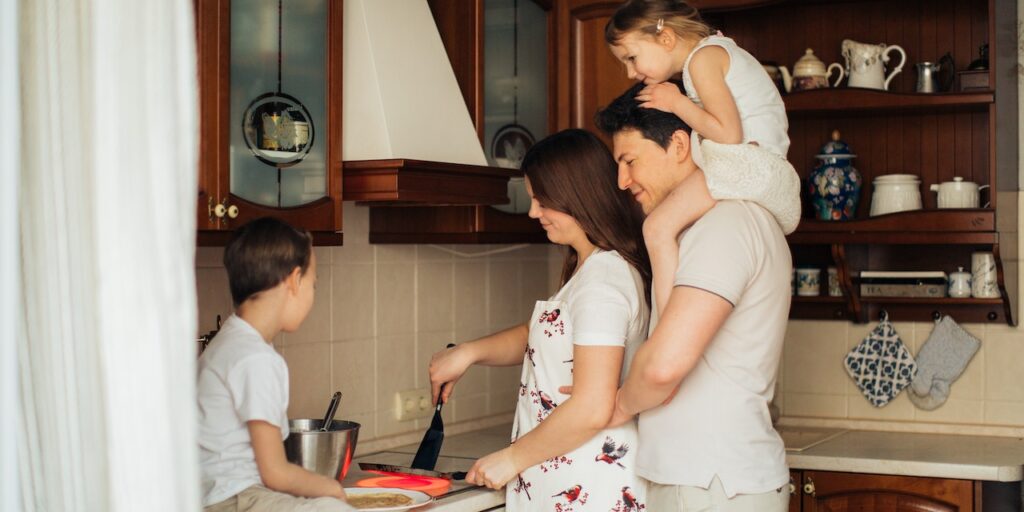 A family cooking in the kitchen, demonstrating kitchen safety for children with autism.