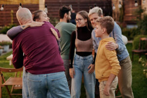 a group of people's hugging each other at a family gathering - Autism 