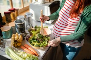 "A girl cooking food in the kitchen, chopping carrots and assorted vegetables on a cutting board." - Autism spectrum disorder