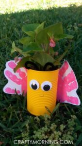 "Yellow bottle with eyes, containing a plant growing inside."