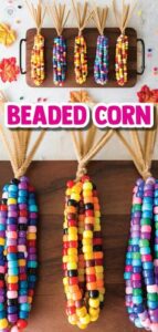 Colorful beaded corn cobs hanging against a wooden backdrop with the text "beaded corn" displayed in bold font at the center.