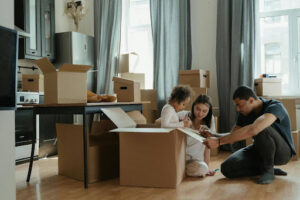 A man and two children sitting on the floor in a living room, with a focus on autism connect