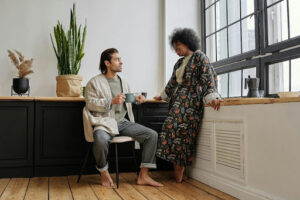 A man and woman sitting on a chair in a room. Image representing autistic individuals connecting through Autism Connect.
