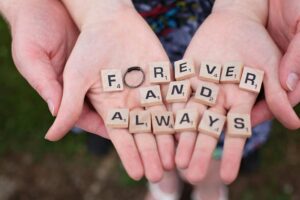 1) A photo of a scrabble board with tiles spelling out "forever and always" at a wedding, symbolizing eternal love and commitment. - Autism Connect 