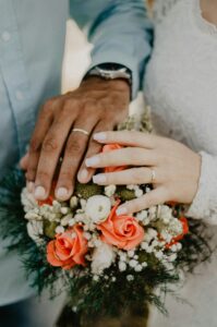 4)A bride and groom holding hands with flowers, symbolizing love and commitment in Autism and Marriage. - Autism Connect 