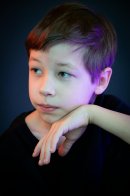 A thoughtful child resting their chin on their hand, reflecting emotional understanding in special children and how emotions are processed differently.